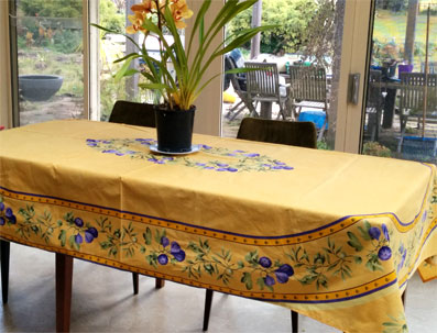 8 seater Provencal tablecloth with oval design of purple figs on a yellow background.
