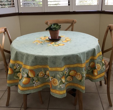 Green and gold coated large round tablecloth with lemons designs