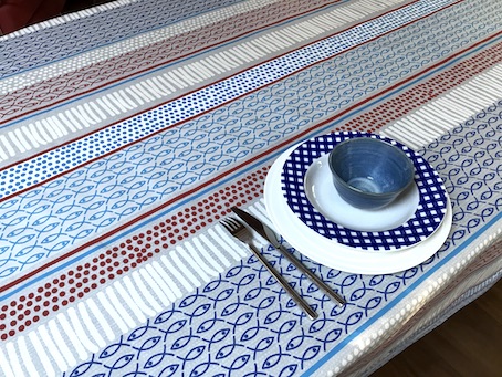 red and blue beach house treated tablecloth with fish designs